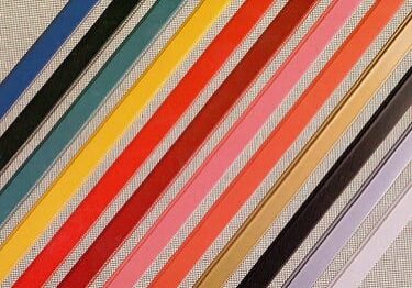 Diagonal colorful fabric ribbons on textured background