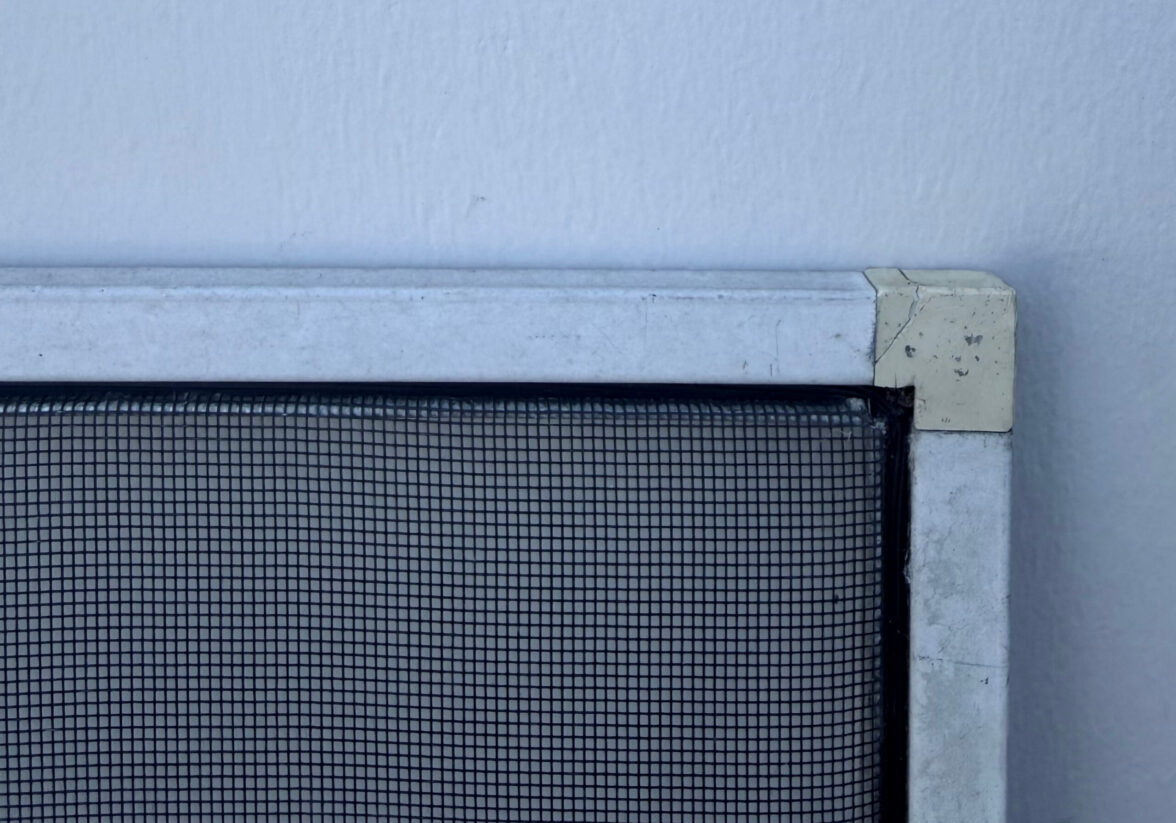 ugly screen and the corner of metal window screen against wall
